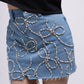 Denim mini skirt with embellished bows