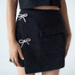 Glitter mini skirt with shiny bows
