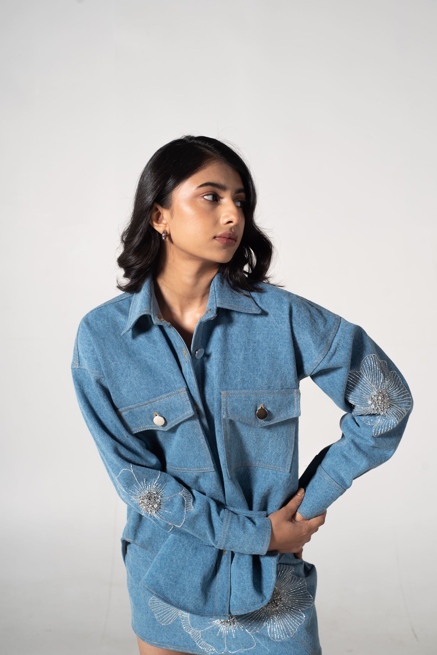 Oversized denim shirt with floral embellishments