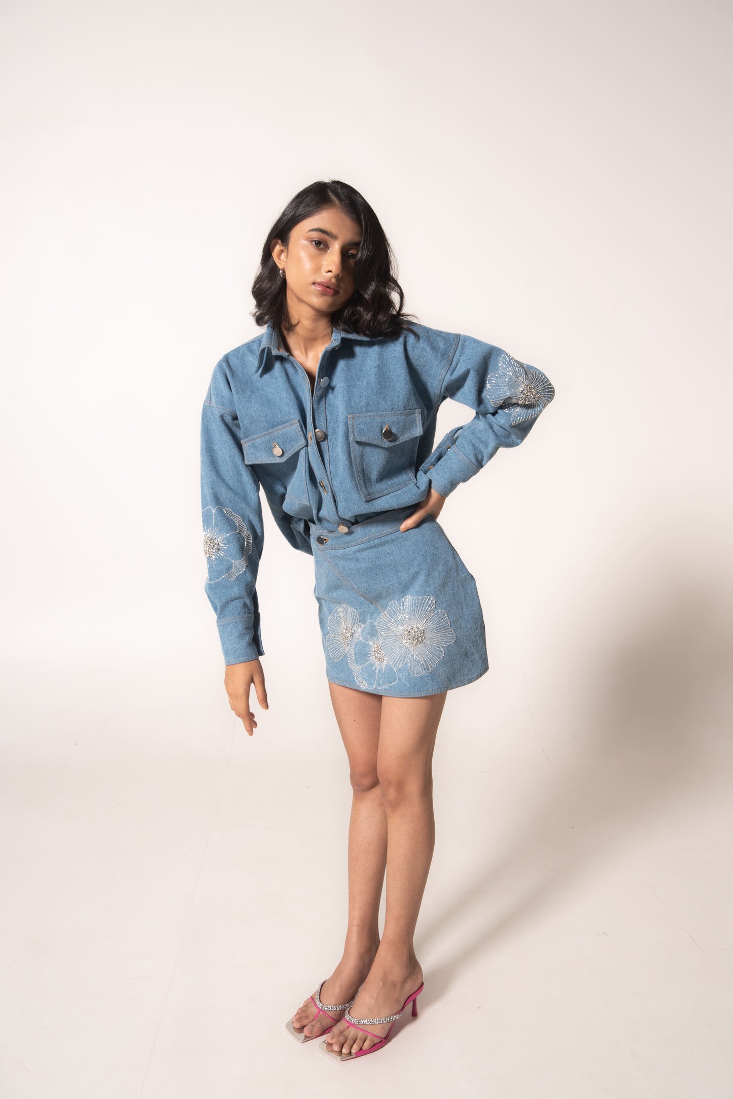 Oversized denim shirt with floral embellishments