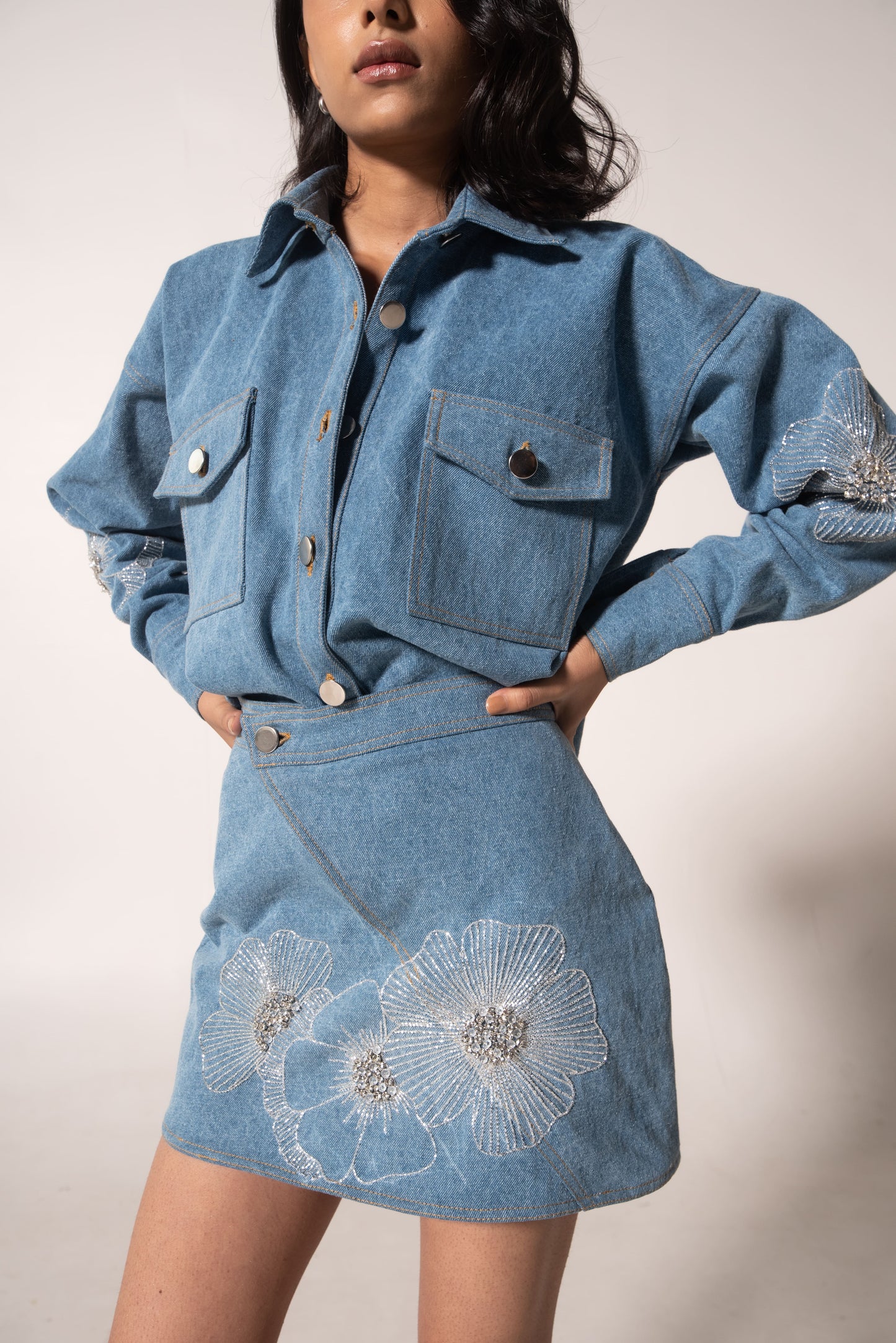 Oversized denim shirt with floral embellishments