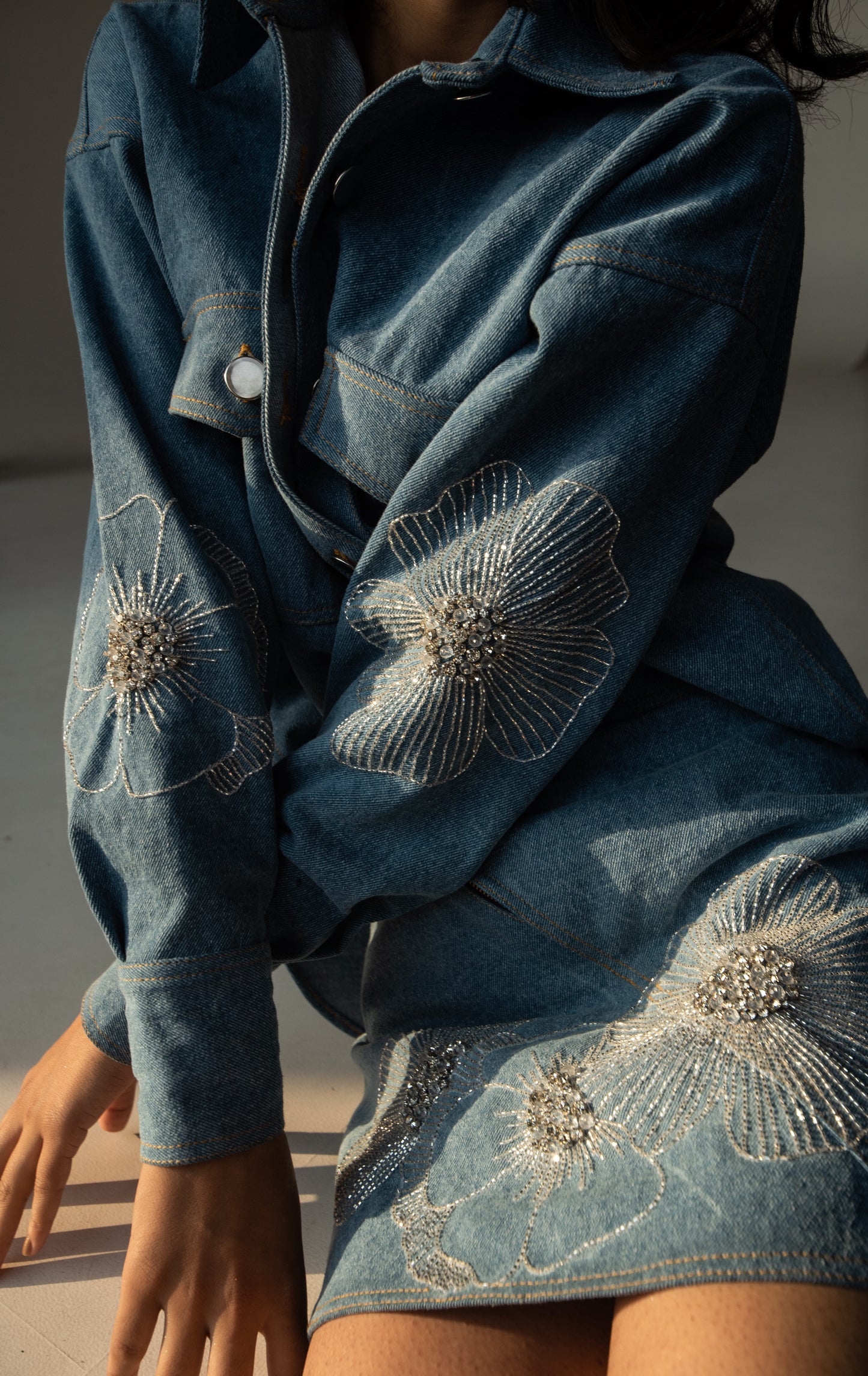 Oversized denim shirt with floral embellishments