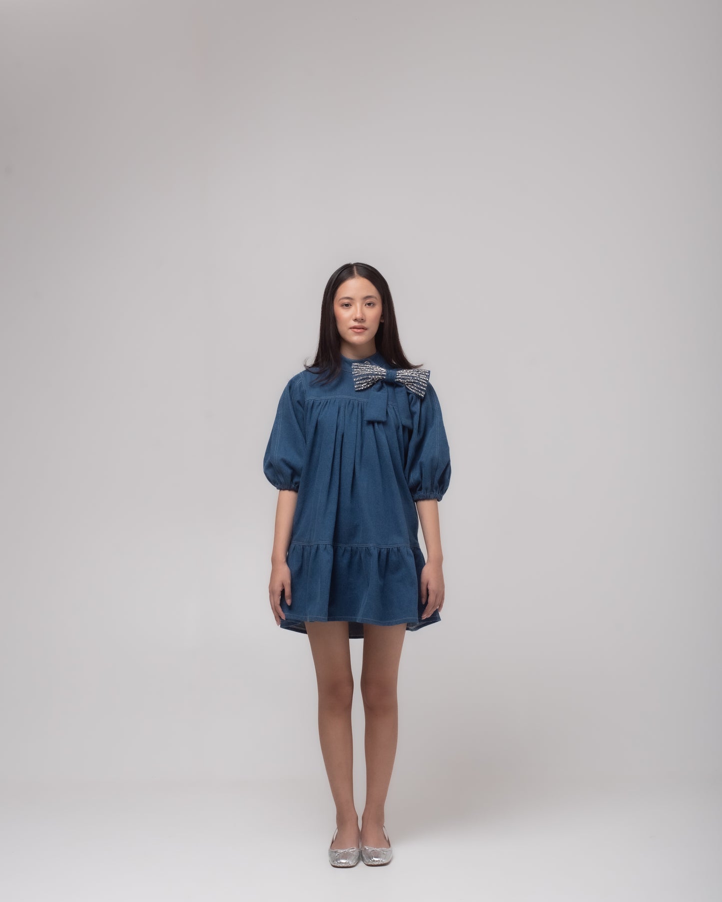 Short denim dress with embellished bow