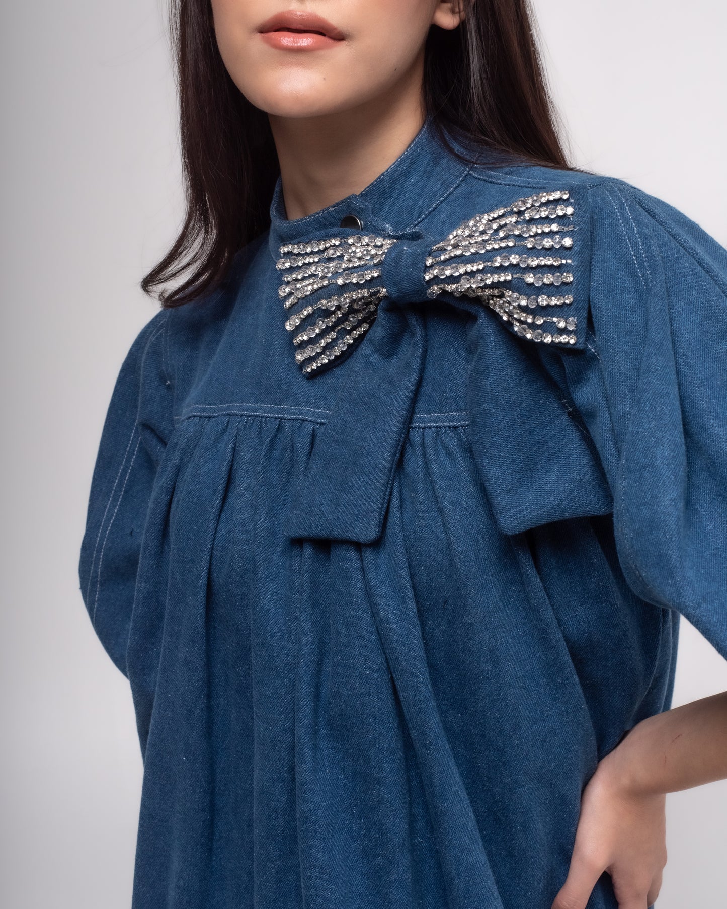 Short denim dress with embellished bow